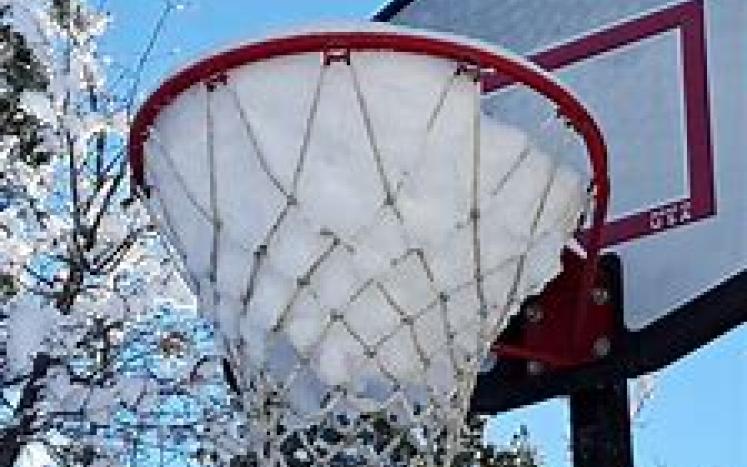 snow covered basketball hoop.